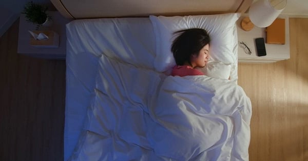 Woman sleeping in white sheets