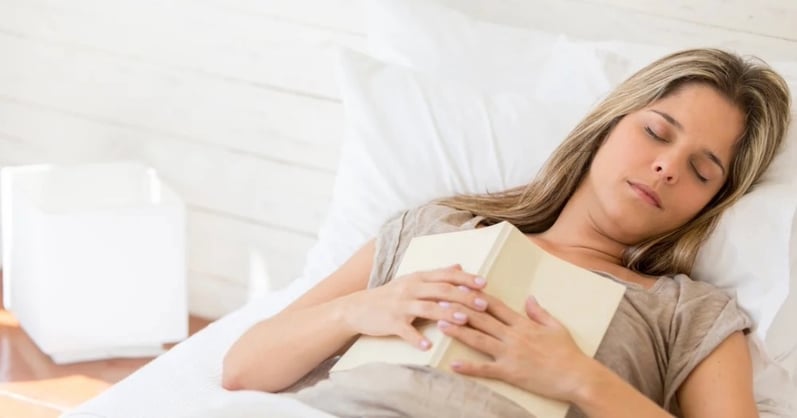 Woman sleeping with a book in her hands