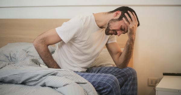 Man in bed with light opened